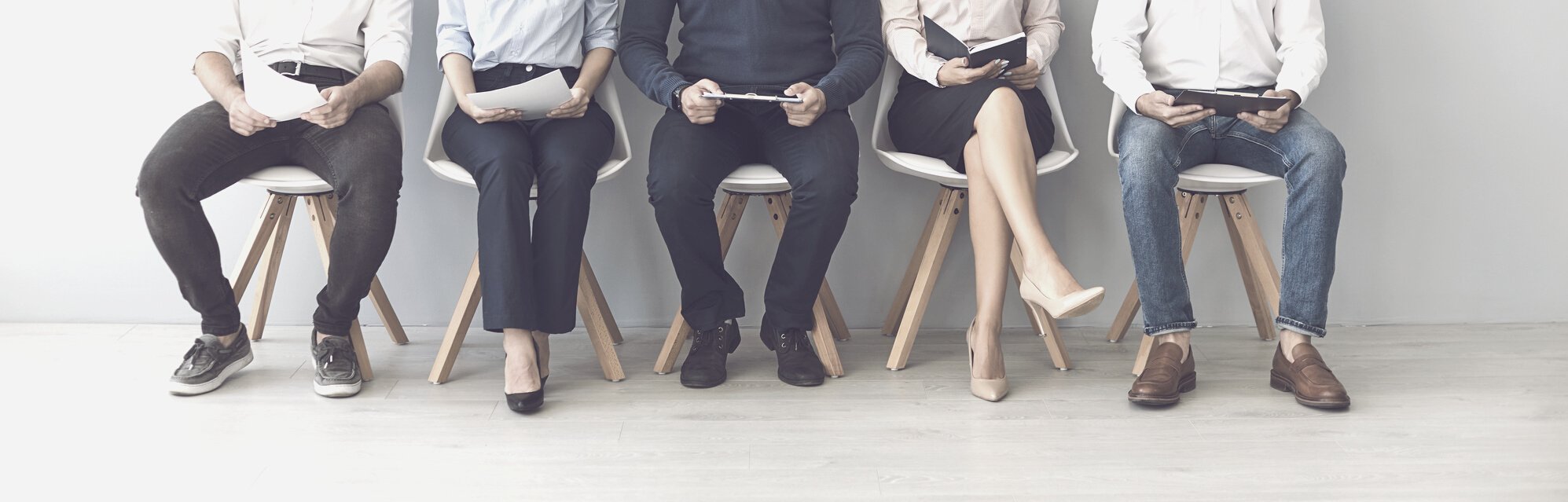 Group of Unrecognizable Candidates Sitting on Chairs Waiting for an Interview.